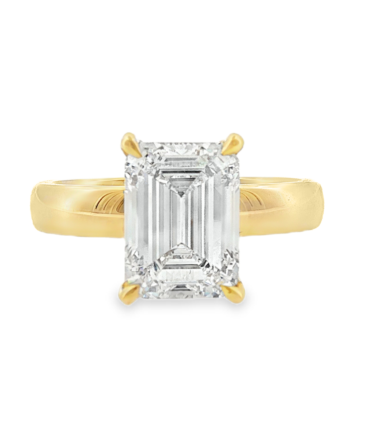 emerald cut solitaire engagement ring rith a lab grown diamond in 18k yellow gold